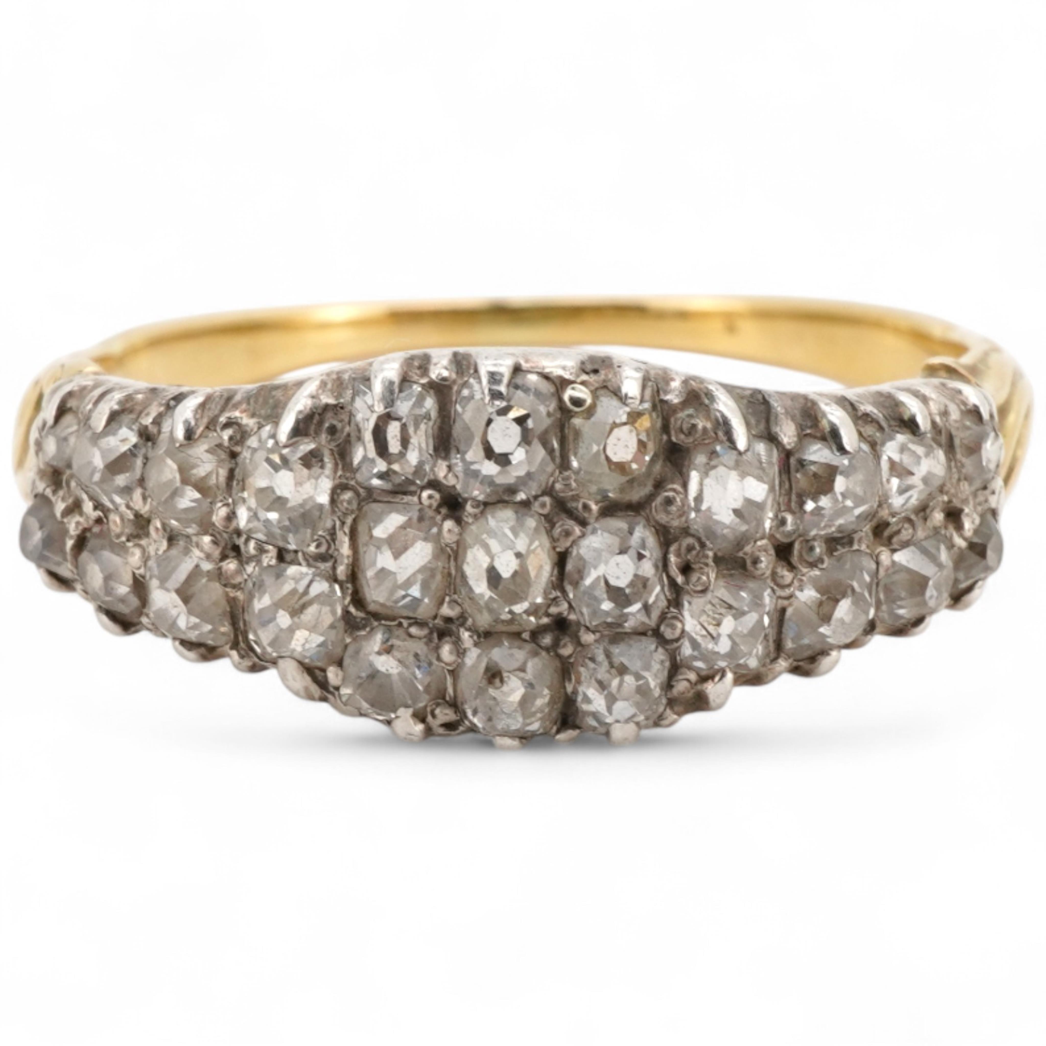 A diamond half-hoop ring, mid 19th century, pavé-set to the front with three rows of cushion-shaped diamonds totalling approximately 0.80 carats, to foliate carved shoulders, mounted in gold, size O, gross weight approxi